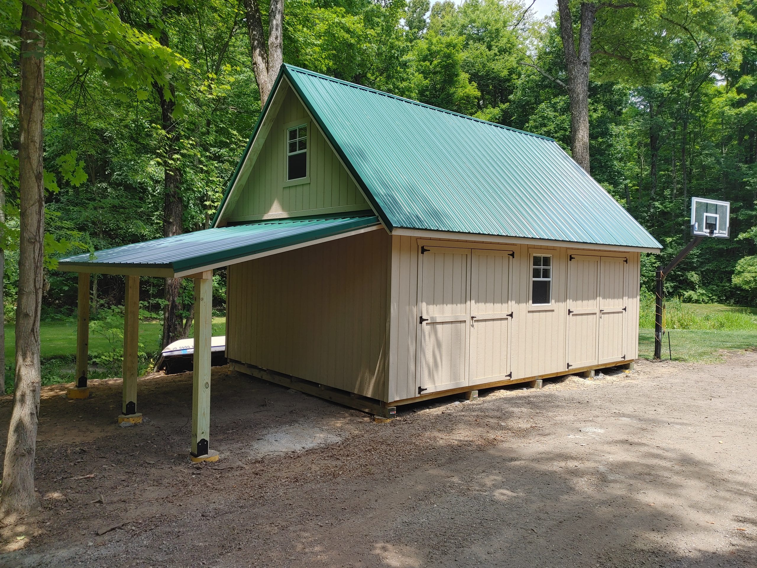 A custom 16'x24' building with two double doors and 10'x16' lean to for wood storage.