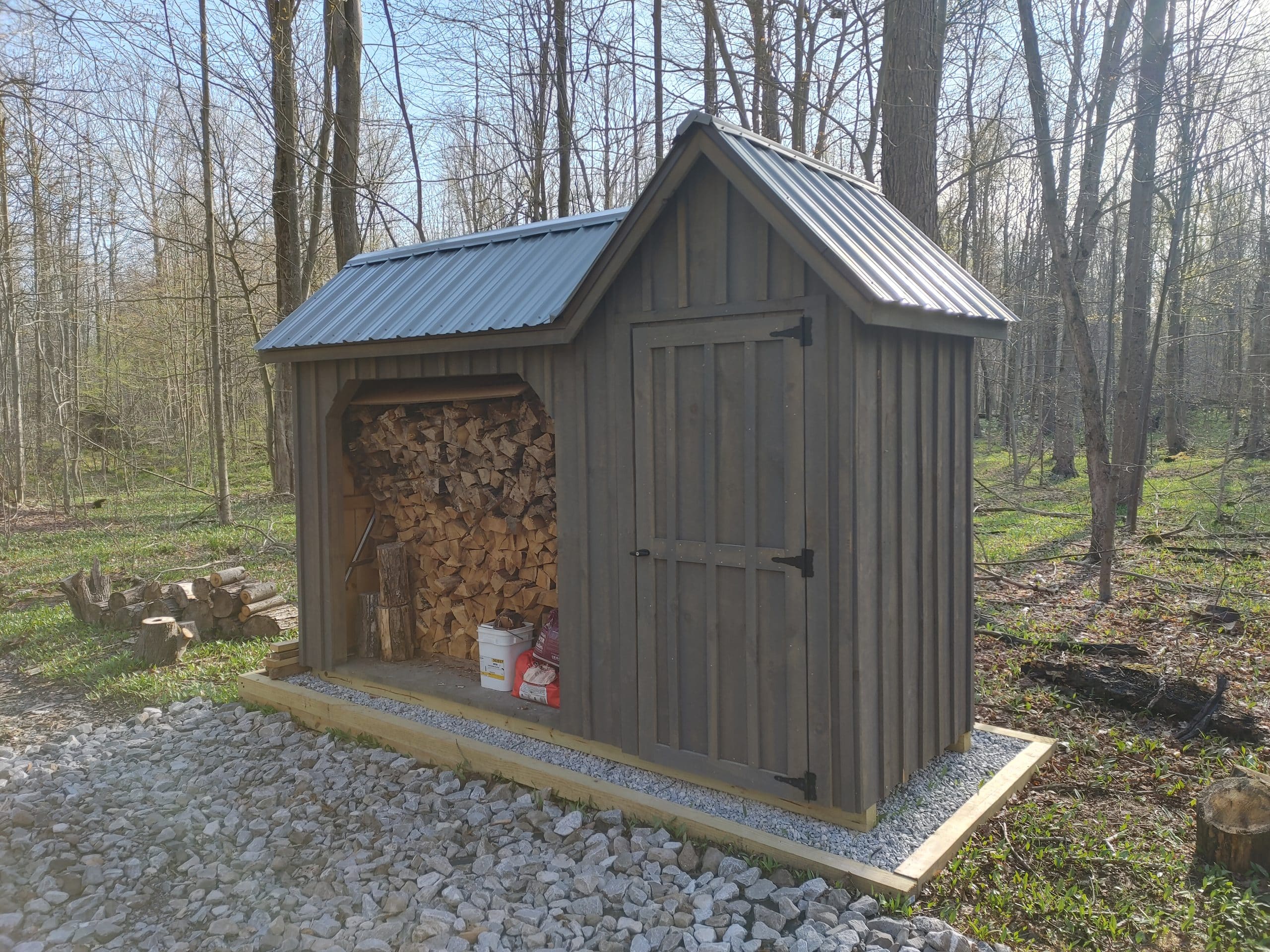 Wood Shed with a composting toilet hidden behind the doors for a one-of-a-kind outhouse!