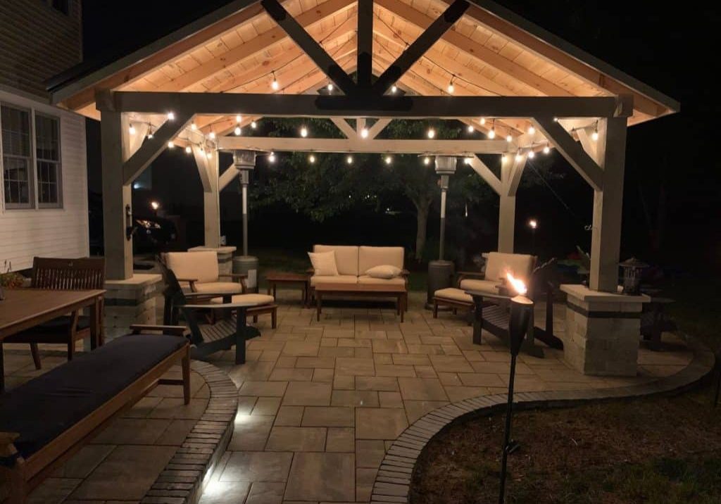 timber frame pavilion on patio with string lights